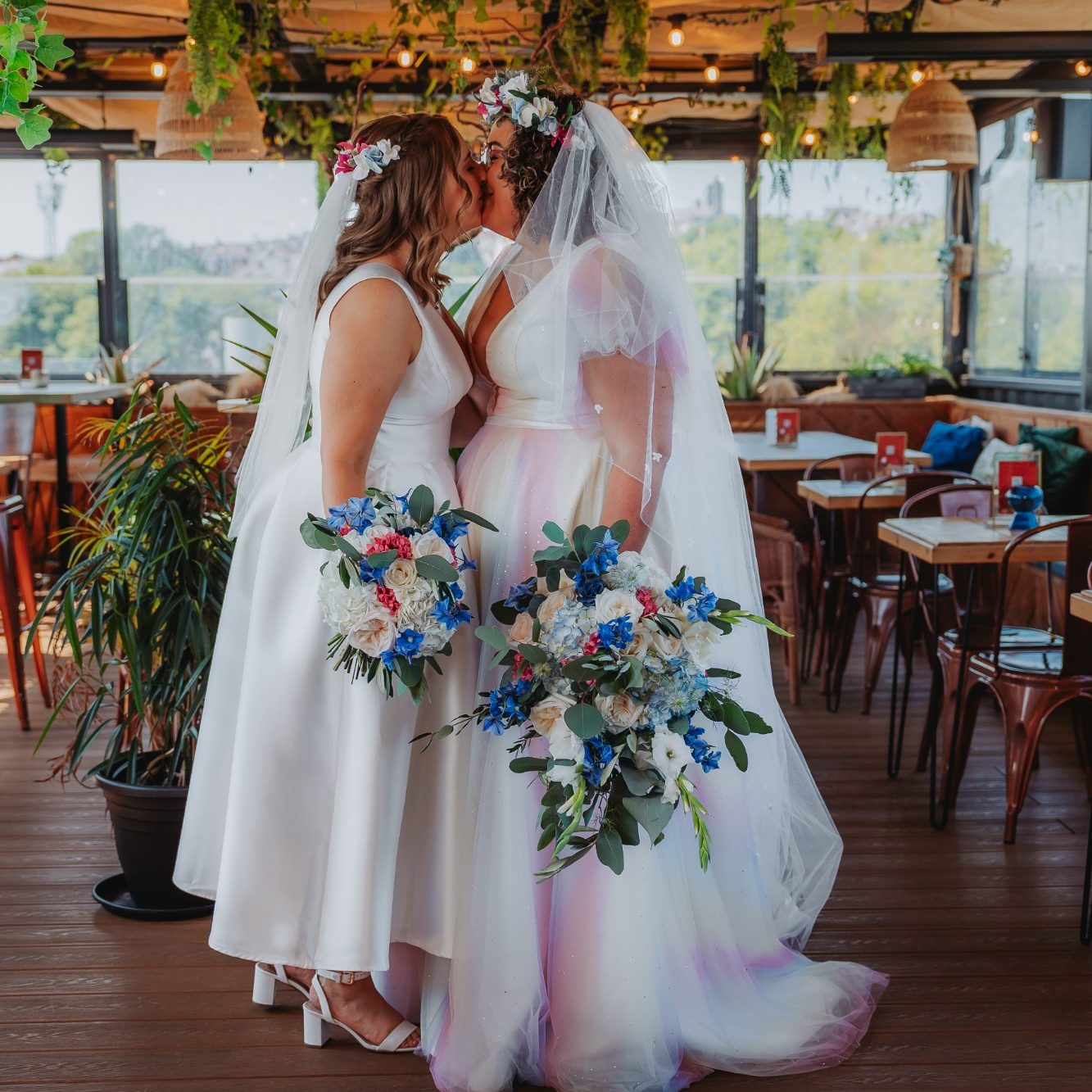 A vibrant flower crown being worn by a smiling bride